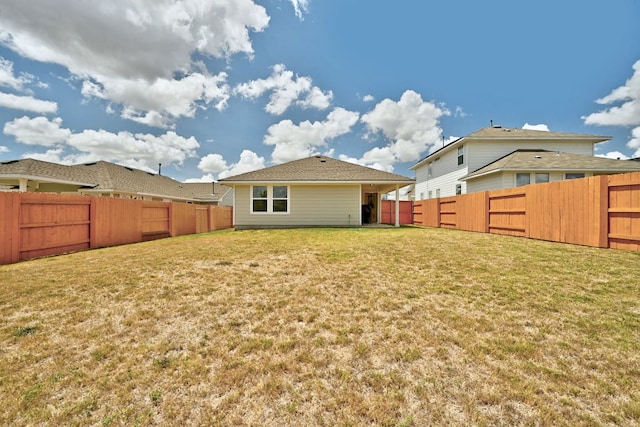 155 Lyndon Dr, San Marcos, TX 78666 - back of property featuring a lawn and a fenced backyard
