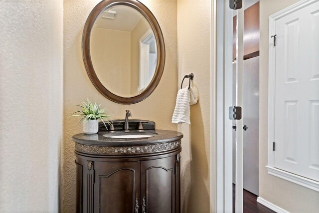 bathroom with vanity and wood finished floors