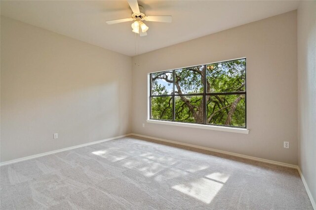 empty room with baseboards, carpet floors, and ceiling fan