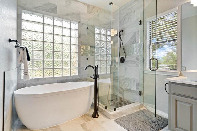 bathroom featuring vanity, a freestanding bath, and a shower stall