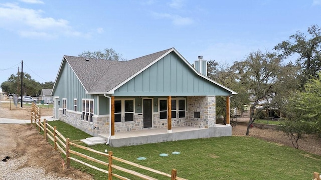 602 Shorewood Dr, Granite Shoals, TX 78654 - rear view of house with a lawn, board and batten siding, roof with shingles, and stone siding