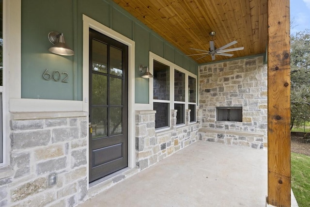602 Shorewood Dr, Granite Shoals, TX 78654 - view of exterior entry with covered porch, ceiling fan, an outdoor stone fireplace, and stone siding