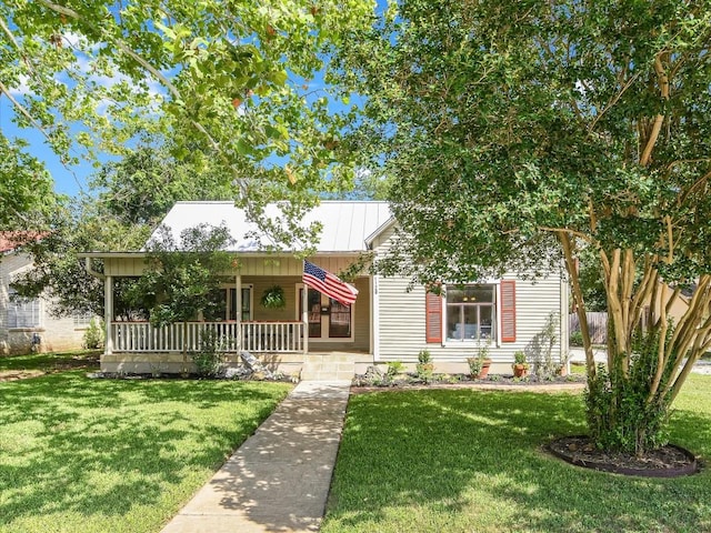 1128 W Hopkins St, San Marcos, TX 78666 - view of front of home with covered porch, metal roof, and a front lawn