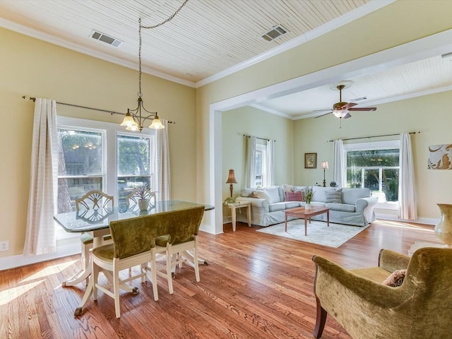 1128 W Hopkins St, San Marcos, TX 78666 - dining space featuring visible vents, crown molding, and wood finished floors
