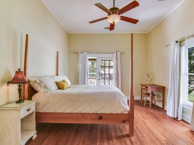 1128 W Hopkins St, San Marcos, TX 78666 - bedroom with access to outside, ornamental molding, baseboards, and wood finished floors
