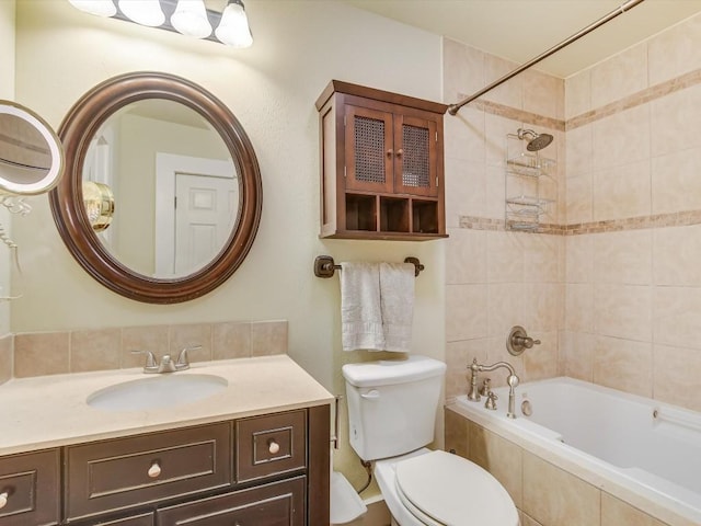 1128 W Hopkins St, San Marcos, TX 78666 - bathroom with tiled shower / bath combo, vanity, and toilet