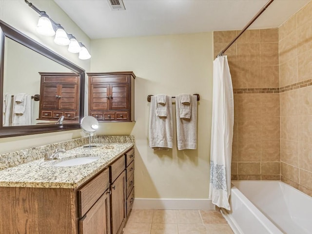 1128 W Hopkins St, San Marcos, TX 78666 - bathroom with visible vents, tile patterned flooring, baseboards, vanity, and shower / bathtub combination with curtain