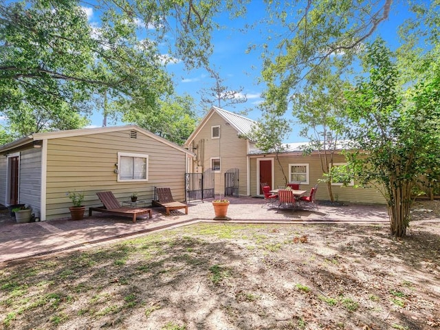 1128 W Hopkins St, San Marcos, TX 78666 - back of property with a patio area and a gate