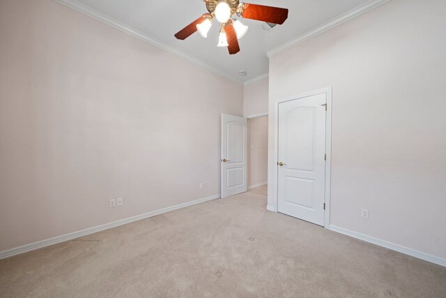 unfurnished bedroom with crown molding, a ceiling fan, baseboards, and carpet