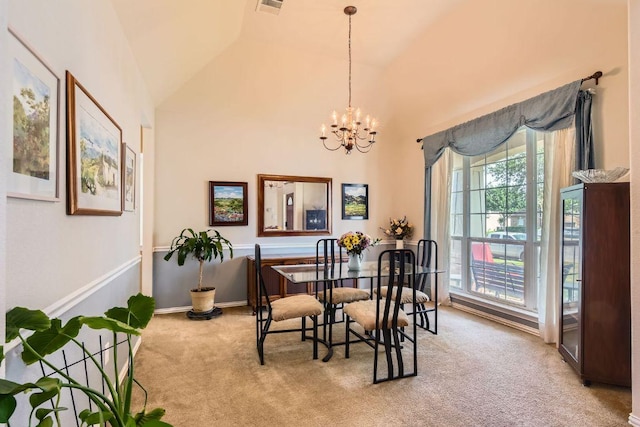 carpeted dining area featuring lofted ceiling and a chandelier
