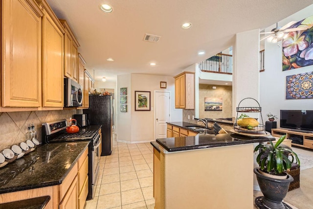 kitchen with appliances with stainless steel finishes, a sink, recessed lighting, backsplash, and visible vents