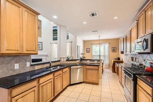 2420 Dakota Dunes Ct, Pflugerville, TX 78660 - kitchen featuring appliances with stainless steel finishes, light tile patterned floors, backsplash, recessed lighting, and dark stone counters