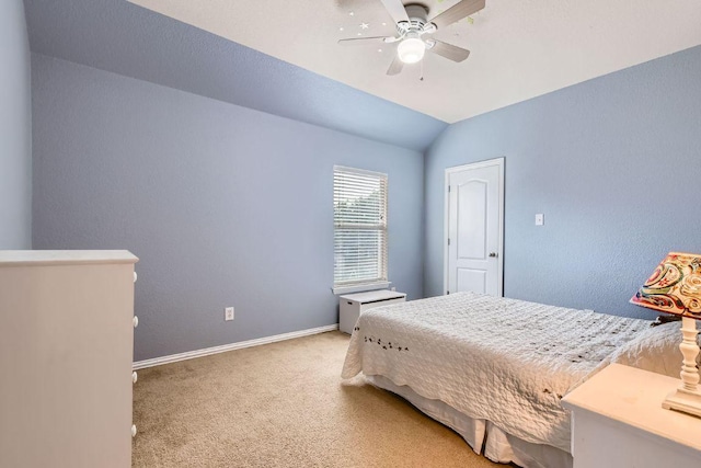 bedroom featuring baseboards, a ceiling fan, vaulted ceiling, and light carpet