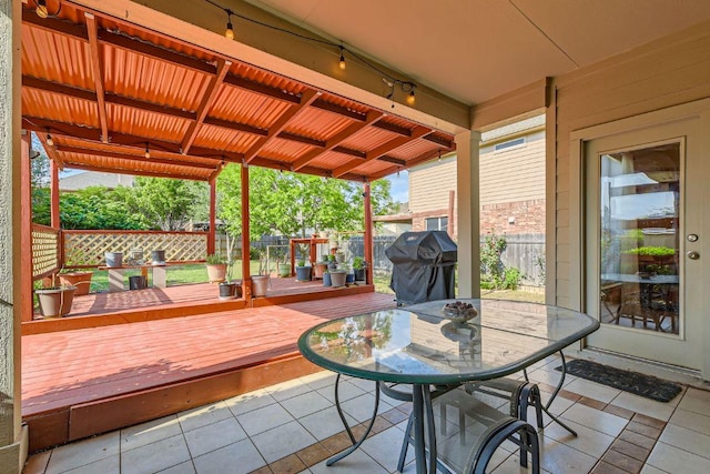 deck featuring a fenced backyard, a patio area, grilling area, and outdoor dining space