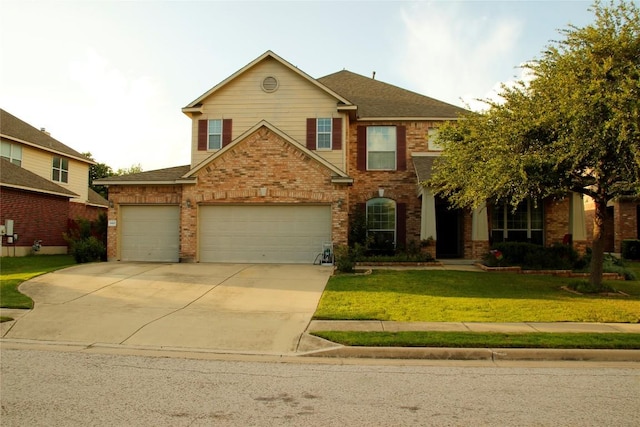 2420 Dakota Dunes Ct, Pflugerville, TX 78660 - view of front of property featuring a front lawn, driveway, brick siding, and an attached garage