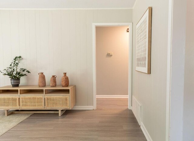 7515 Daugherty St, Austin, TX 78757 - corridor featuring wood finished floors, baseboards, and crown molding
