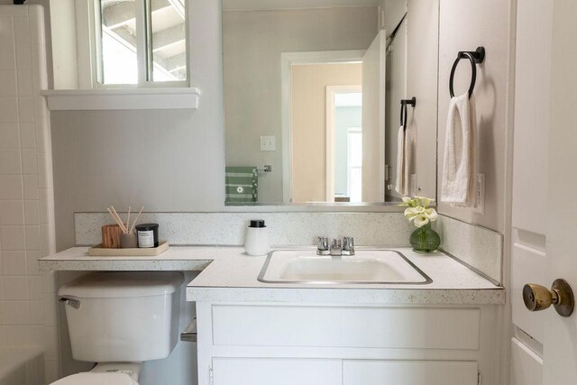 7515 Daugherty St, Austin, TX 78757 - bathroom with vanity and toilet