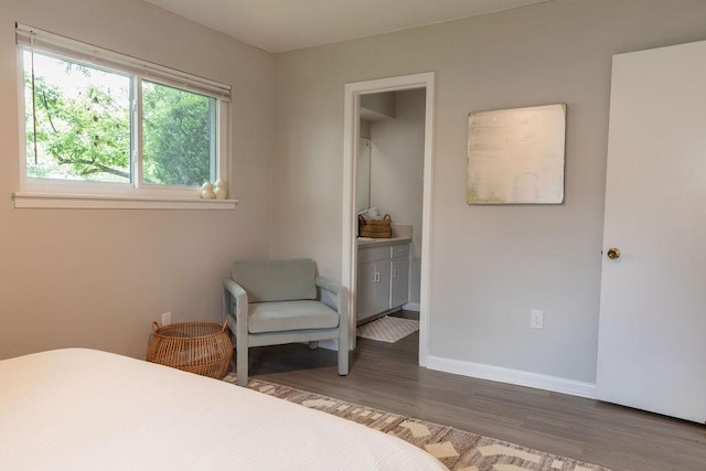 bedroom featuring baseboards and wood finished floors