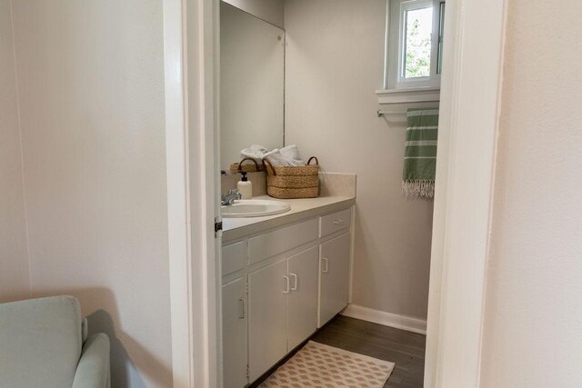 7515 Daugherty St, Austin, TX 78757 - bathroom featuring vanity, wood finished floors, and baseboards