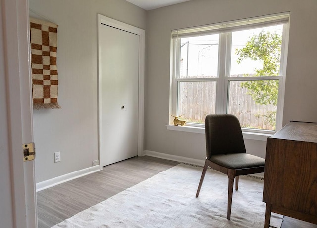 office space featuring baseboards and wood finished floors