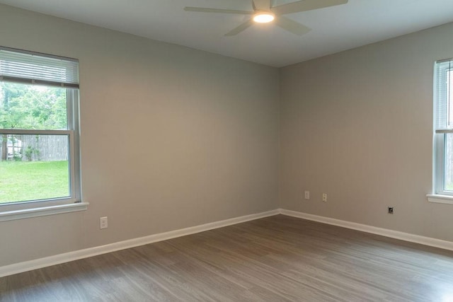 unfurnished room with baseboards, ceiling fan, and wood finished floors
