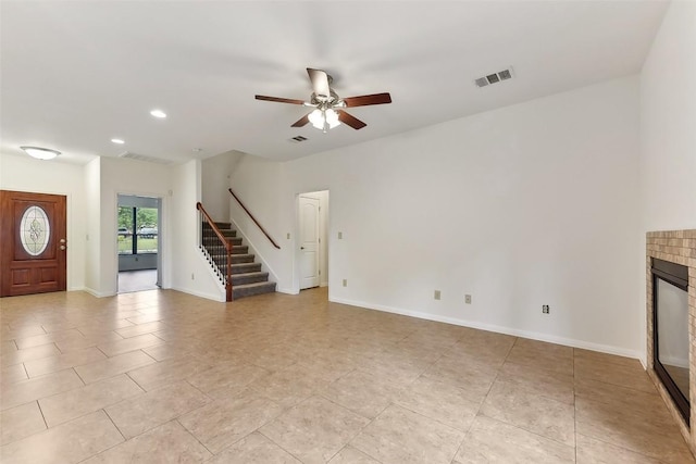 unfurnished living room with a ceiling fan, visible vents, stairs, light tile patterned floors, and recessed lighting