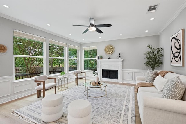 living area featuring a high end fireplace, a ceiling fan, recessed lighting, and visible vents