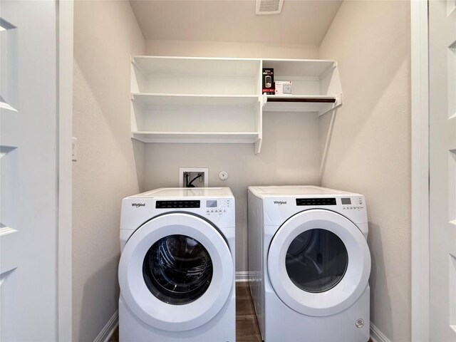 laundry room with baseboards, laundry area, independent washer and dryer, and visible vents