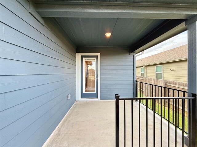 view of exterior entry featuring fence