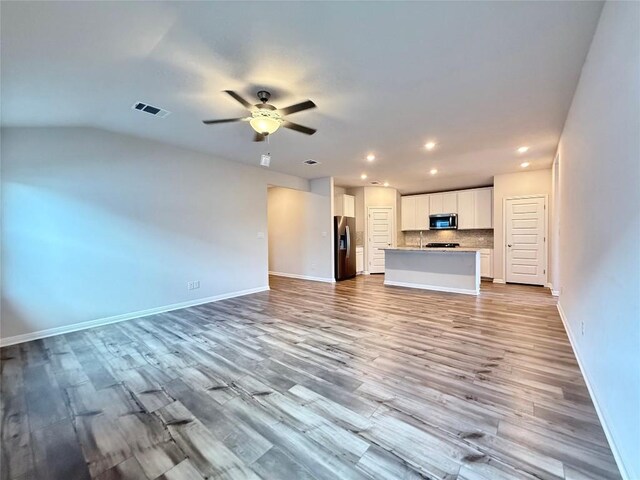 unfurnished living room with light wood-style floors, recessed lighting, baseboards, a ceiling fan, and visible vents