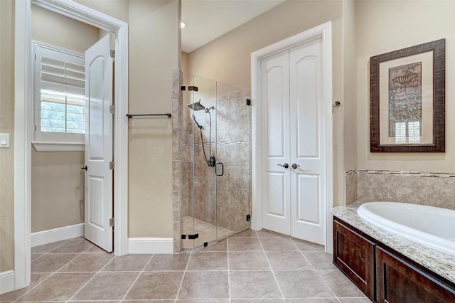423 Bella Montagna Cir, Austin, TX 78734 - bathroom featuring a stall shower, tile patterned flooring, and a garden tub