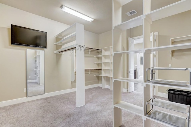 walk in closet featuring carpet flooring and visible vents