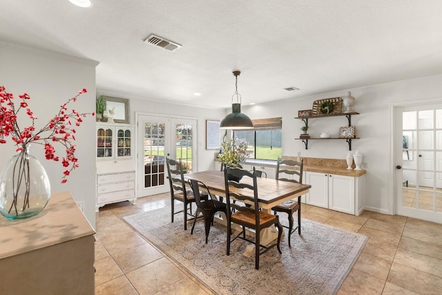 1418 Jackson Rd, Kerrville, TX 78028 - dining room with crown molding, visible vents, light tile patterned flooring, recessed lighting, and french doors