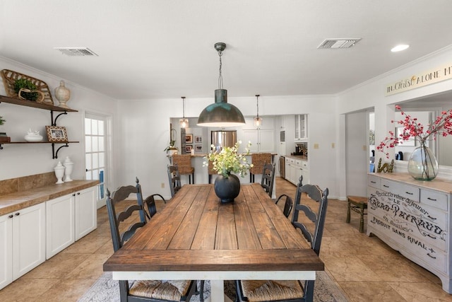 1418 Jackson Rd, Kerrville, TX 78028 - dining area with visible vents, crown molding, and light tile patterned floors