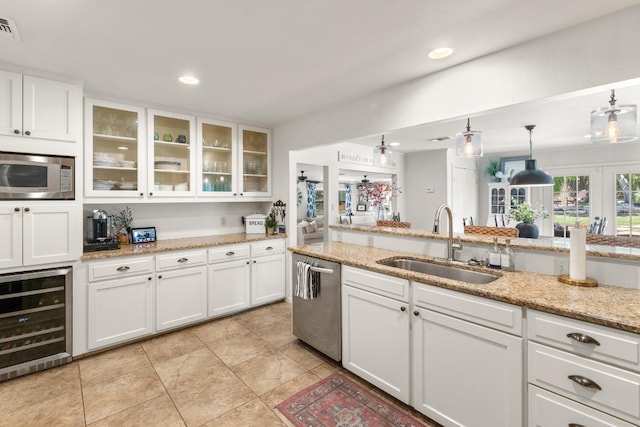 1418 Jackson Rd, Kerrville, TX 78028 - kitchen with a sink, white cabinetry, wine cooler, and stainless steel appliances
