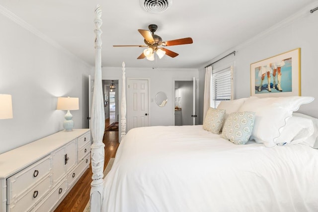 1418 Jackson Rd, Kerrville, TX 78028 - bedroom featuring visible vents, crown molding, dark wood-type flooring, and ceiling fan