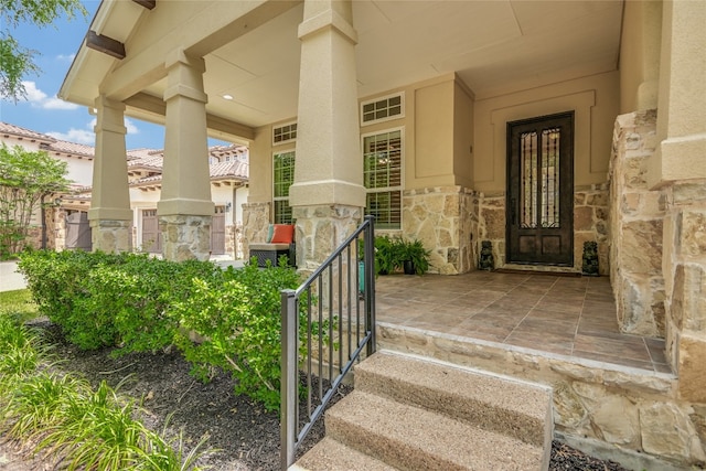1916 Wimberly Ln, Austin, TX 78735 - view of exterior entry featuring stone siding, stucco siding, and covered porch