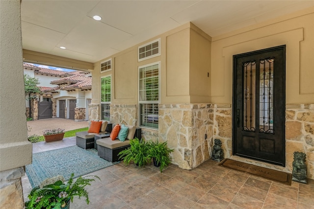 doorway to property with stone siding and stucco siding