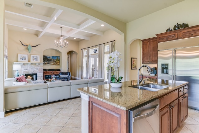 1916 Wimberly Ln, Austin, TX 78735 - kitchen featuring stainless steel appliances, arched walkways, light tile patterned floors, beamed ceiling, and coffered ceiling