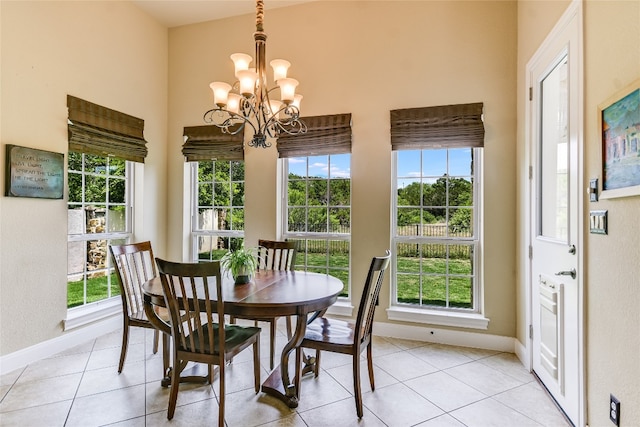 1916 Wimberly Ln, Austin, TX 78735 - dining room featuring plenty of natural light, a chandelier, baseboards, light tile patterned floors, and a high ceiling