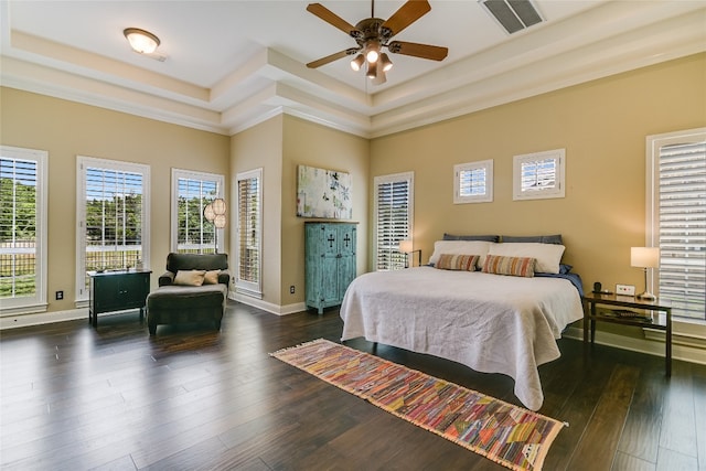 bedroom with a raised ceiling, baseboards, dark wood-type flooring, and visible vents