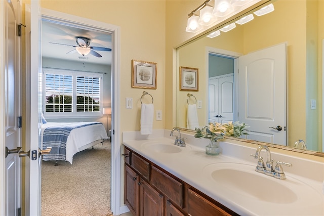 ensuite bathroom featuring double vanity, ceiling fan, a sink, and ensuite bathroom