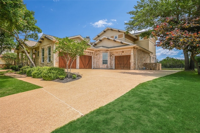 view of front of property with a garage, a front yard, stone siding, and concrete driveway