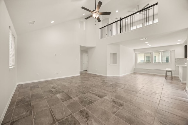 2813 Hopi Path Unit 11, Georgetown, TX 78628 - unfurnished living room featuring baseboards, ceiling fan, visible vents, and a high ceiling