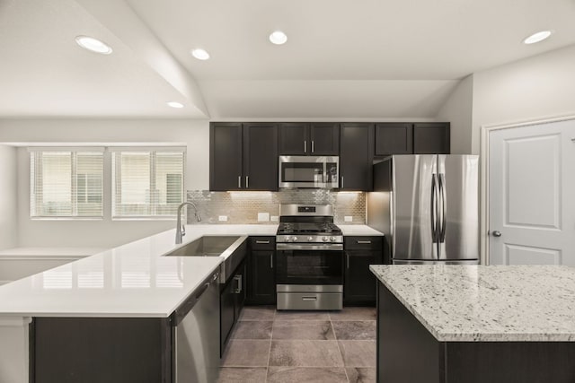 2813 Hopi Path Unit 11, Georgetown, TX 78628 - kitchen featuring appliances with stainless steel finishes, a sink, dark cabinetry, recessed lighting, and backsplash