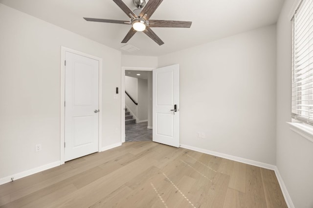 2813 Hopi Path Unit 11, Georgetown, TX 78628 - unfurnished bedroom with a ceiling fan, baseboards, visible vents, and light wood finished floors