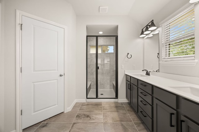 2813 Hopi Path Unit 11, Georgetown, TX 78628 - bathroom with double vanity, baseboards, a sink, and a stall shower