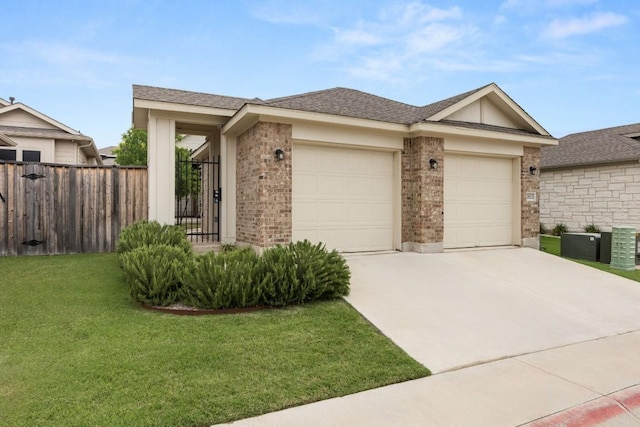 2813 Hopi Path Unit 11, Georgetown, TX 78628 - view of front of property featuring fence, an attached garage, a front lawn, brick siding, and driveway