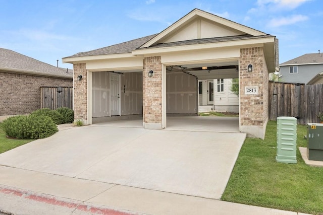 2813 Hopi Path Unit 11, Georgetown, TX 78628 - view of front of home with brick siding, an attached garage, fence, and driveway
