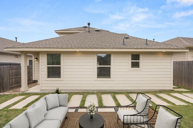 2813 Hopi Path Unit 11, Georgetown, TX 78628 - back of property featuring a fenced backyard, a shingled roof, a patio area, and outdoor lounge area